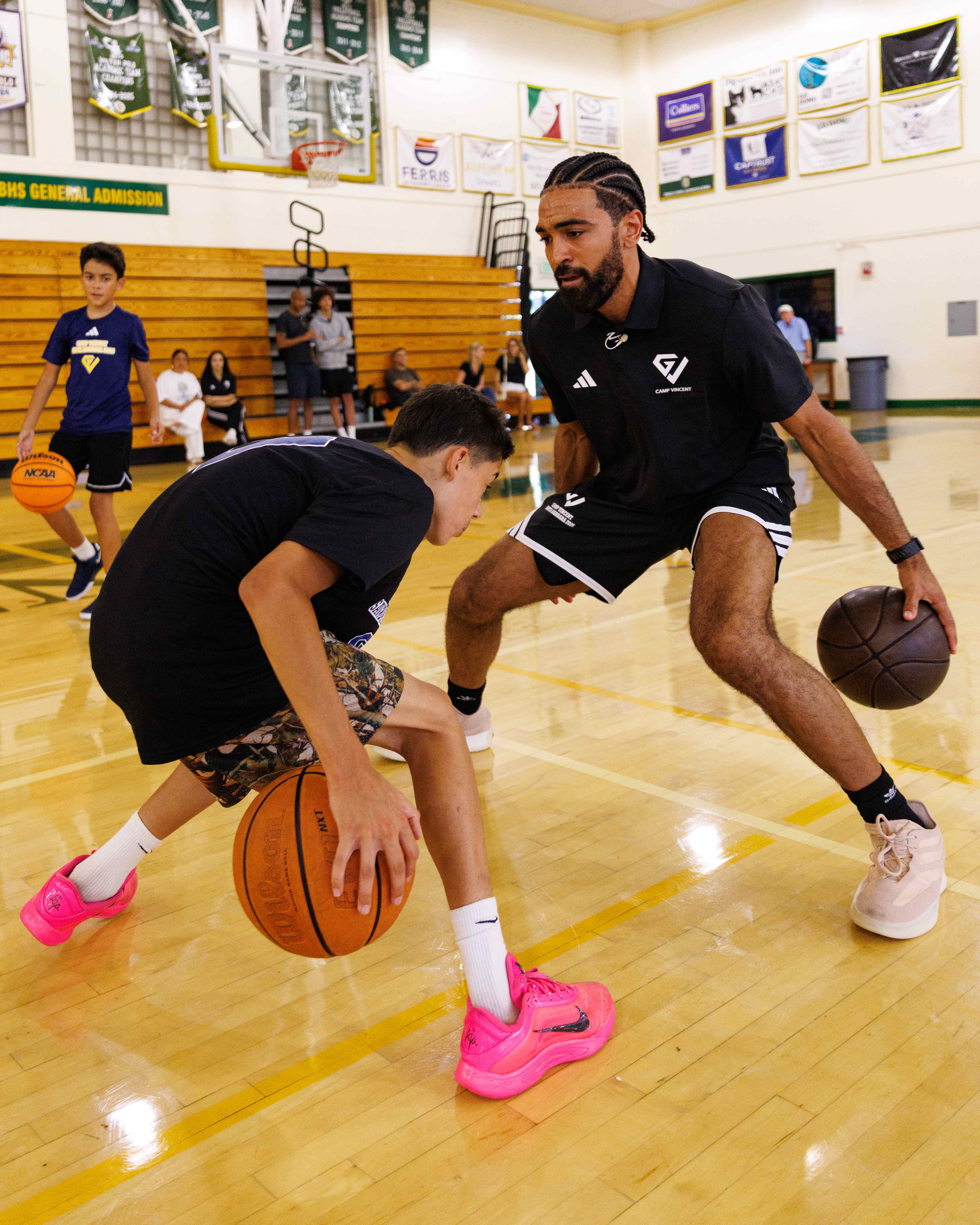 Gabe Vincent coaching a player during a Camp Vincent drill