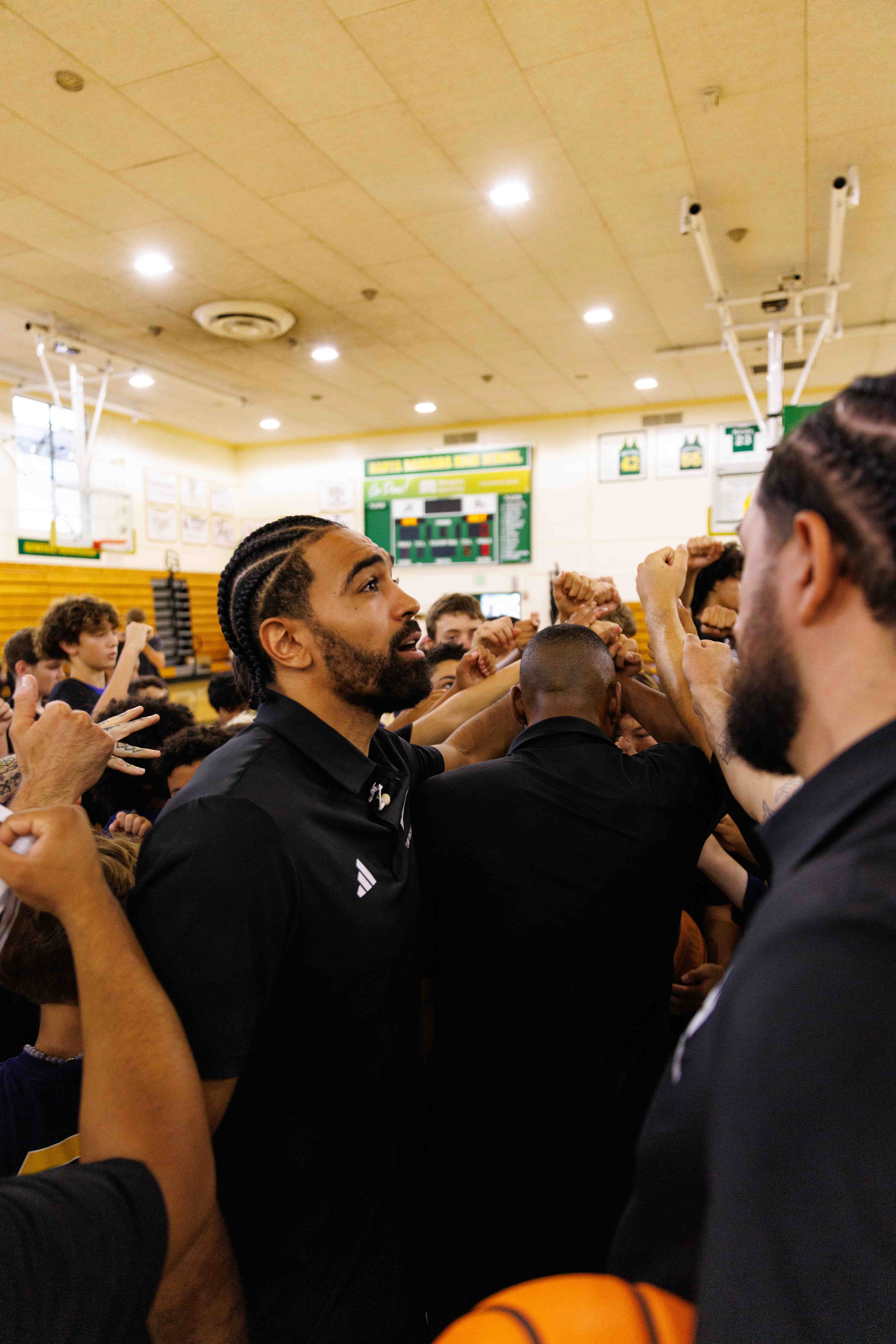Gabe Vincent leading athletes in a Camp Vincent huddle